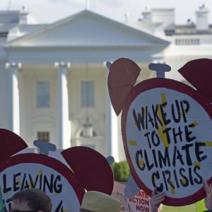 Climate protestors with signs outside White House
