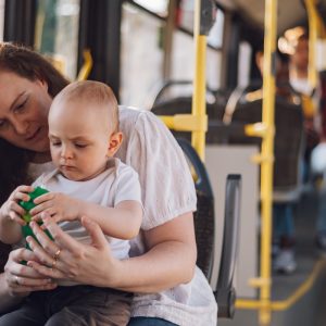 Woman carrying her child on a public bus
