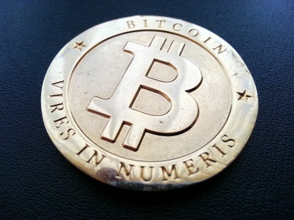 Image of coin with "Bitcoin Vires in Numeris" on it.