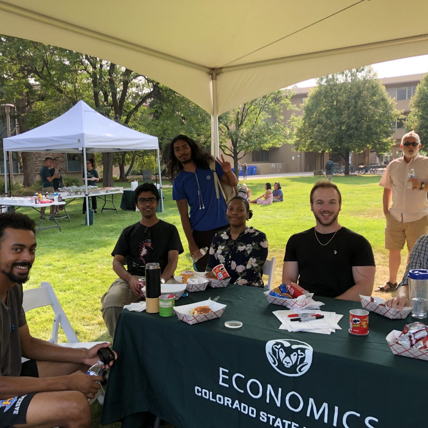Graduate students outside at tent for the Graduate Student Social